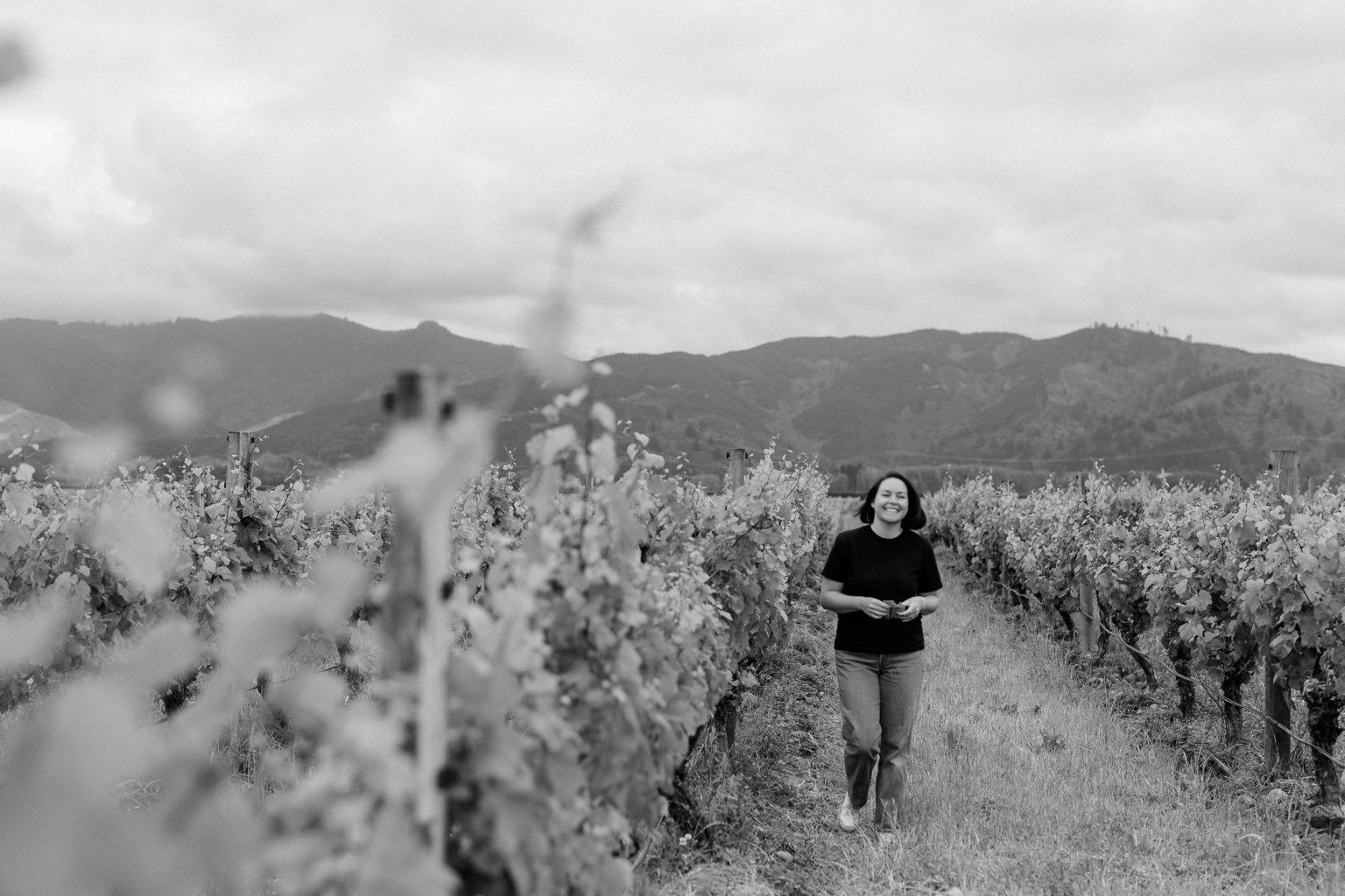 Chelsea Macdonald walking through a Marlborough vineyard